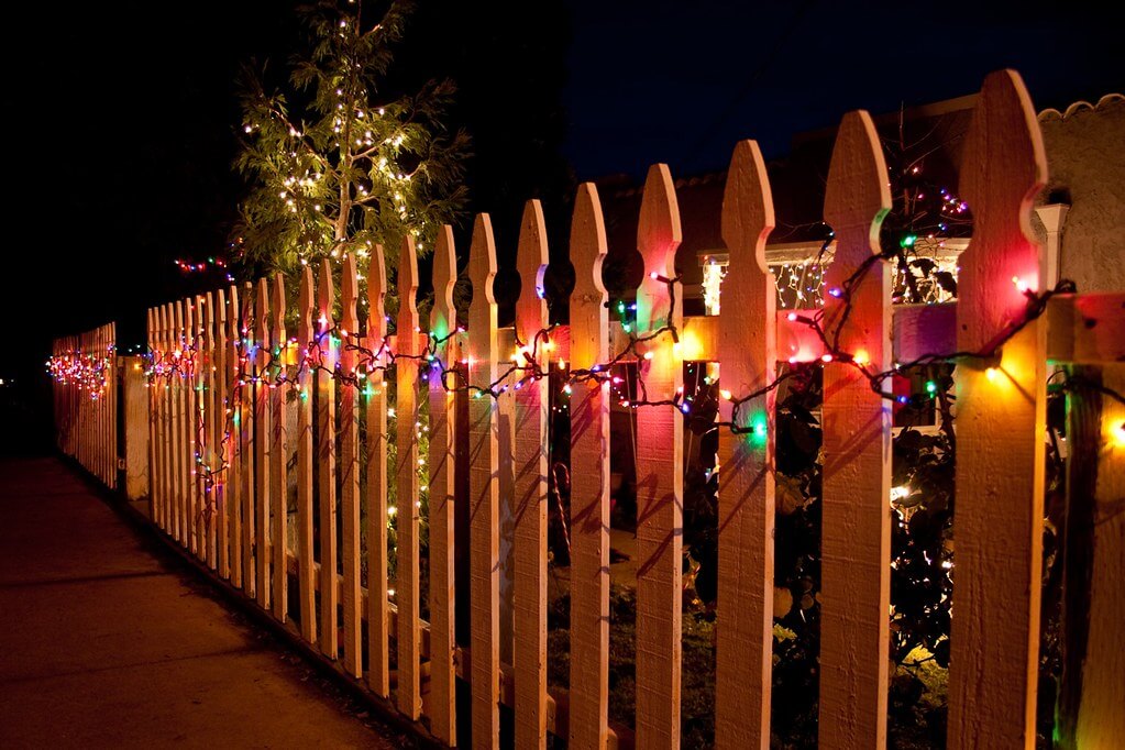 fence with a lighted fairy lights