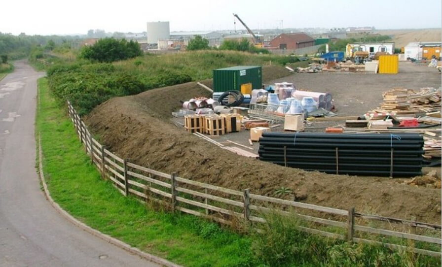 Fenced property with piles of construction materials